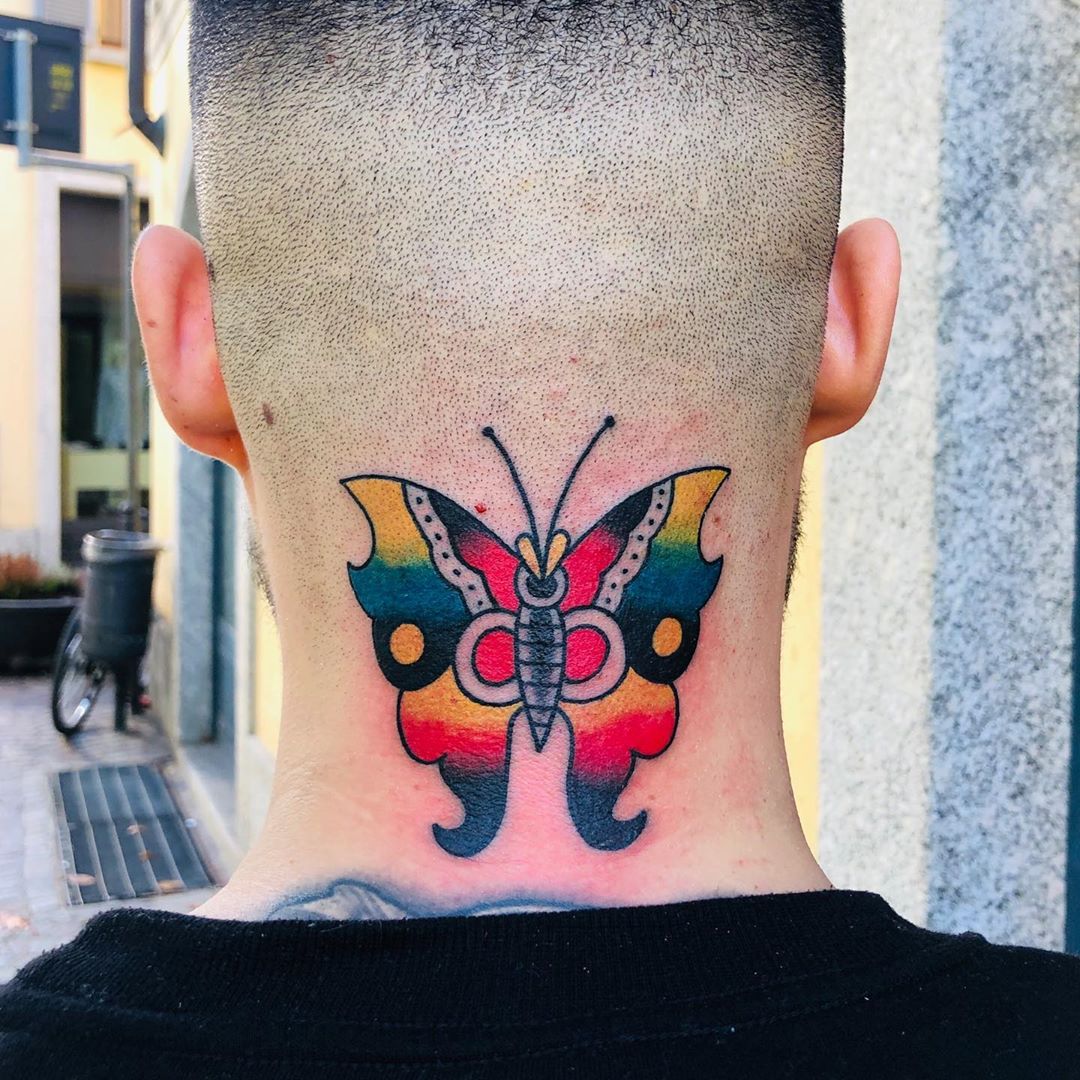 large color traditional tattoo on back of man's neck of a surrealistic butterfly