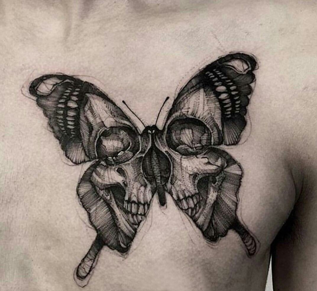 large black and grey traditional tattoo on man's chest of a surrealistic butterfly with skull face in its wings
